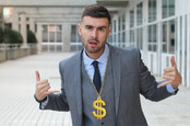 Businessman rocking golden necklace with dollar sign