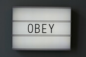 Obey text on a board