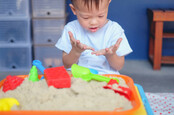 boy with sandbox dirty hands