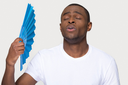 Guy cooling himself down with fan