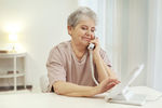 older woman dials landline