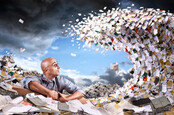 man about to become submerged by giant wave of paperwork