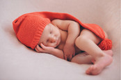 Newborn baby sleeps in woolly hat