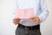 Shutterstock image of a man with a pink slip