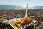 fish and chips takeaway container on beach