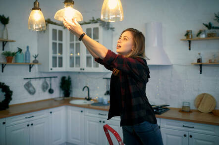 Someone changing a light bulb