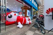 Huawei store in China with fallen promotional inflatable character on the ground