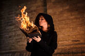 A person holding a burning book