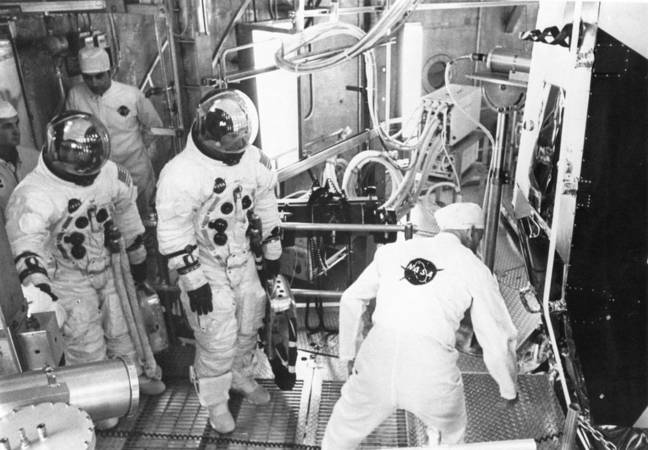 In this image, Apollo 11 backup crew members Fred Haise (left) and Jim Lovell prepare to enter the Lunar Module for an altitude test.