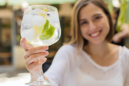 Young woman in a restaurant with gin and tonic