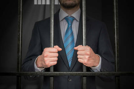Someone behind bars in a suit