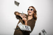 A woman throwing money in the air
