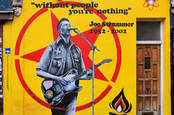 Street art remembrance painting by Emma Harrison and Gary Loveridge of Joe Strummer, punk rock guitarist, songwriter and lead vocalist of Clash, in west London, UK. - Image