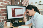 worker in front of wannacry lock screen