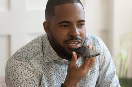 man talks into iphone: asks siri