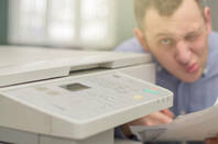 worried guy squints at printer
