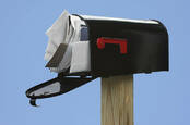 Image of an overstuffed mail box