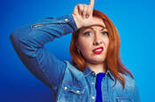 Someone holding the loser L symbol to their forehead
