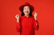 A woman in a red hat looking happy