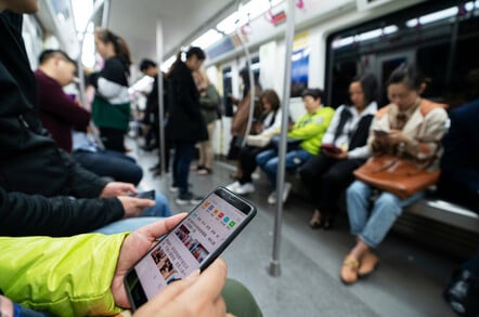 Closeup of a person using a Huawei smartphone on public transport in Chengdu, Sichuan province, China