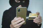 A criminal using a phone for fraud
