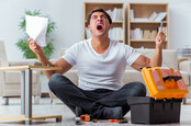 Man not enjoying assembling furniture at home