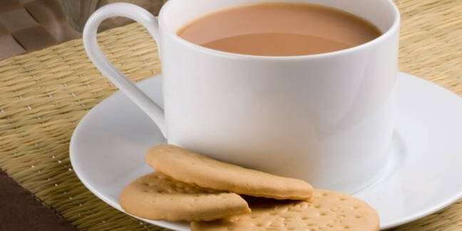 milk tea in a tea cup with a rich tea biscuit - nice!