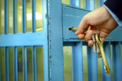 Keys in the door of a jail cell