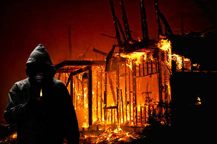 arsonist in front of burning building