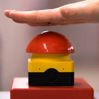 Hand above a red emergency button