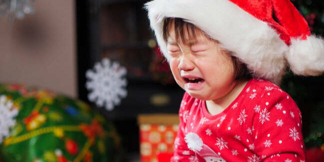 little girl cries in christmas hat