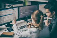 Two people writing code