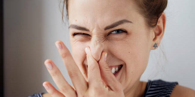 woman recoils because of bad smell