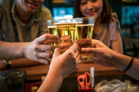 People clinking together beer glasses