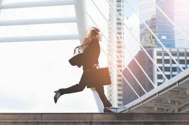 A businesswoman running in a hurry