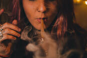 A woman smoking a blunt