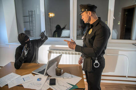 A police officer catches an office burglar