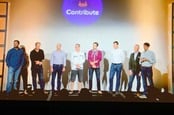 Eight men and a woman at GitLab's Contribute event