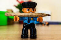 Figurine of a policeman with a  pencil 