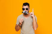 A man disguised with sunglasses and a fake mustache