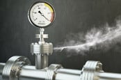 Gas or steam leaking from an industrial pressure gauge