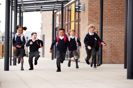 schoolchildren run outside to their parents