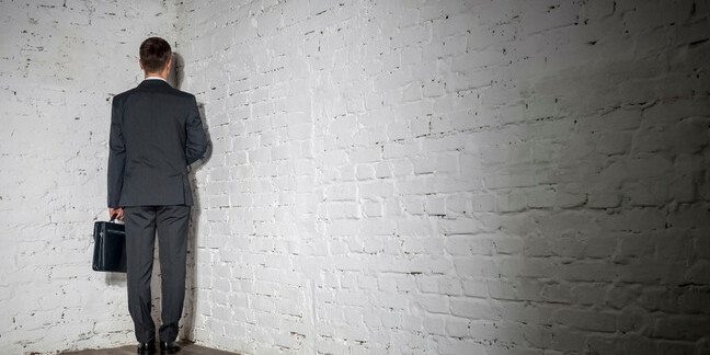 Businessman stands in a corner