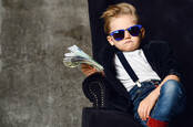 A kid holding a wad of cash