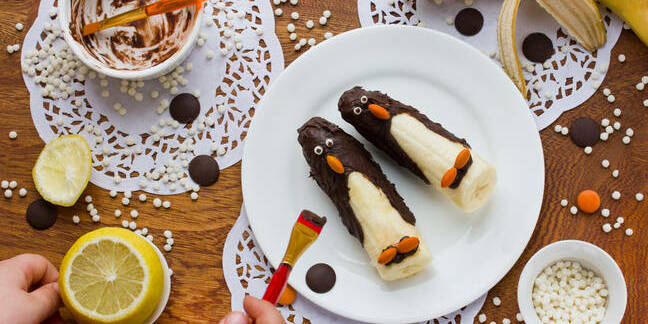 bananas dipped in chocolate with orange icing beaks - look like penguins