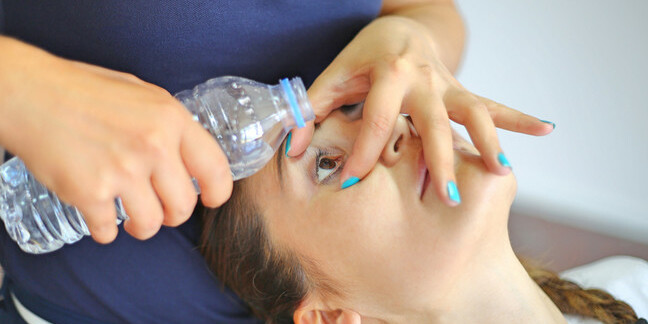 Woman getting eye washed out