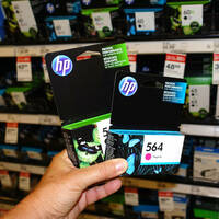 Someone holding some HP ink cartridges