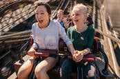 Two people enjoying a rollercoaster ride