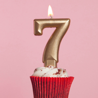 Number 7 gold candle in a cupcake
