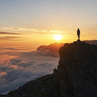 person stands on edge of cliff